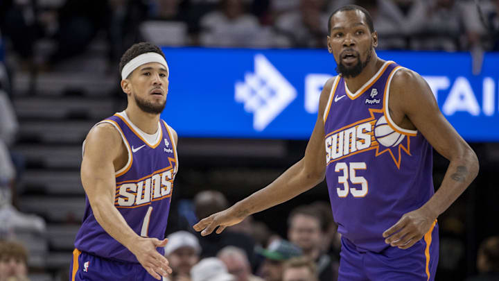 Apr 20, 2024; Minneapolis, Minnesota, USA; Phoenix Suns guard Devin Booker (1) shakes hands with