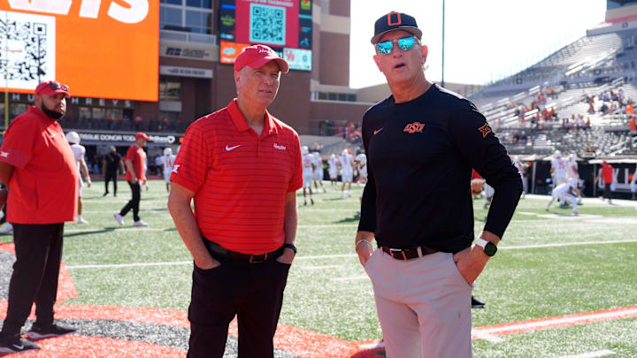 Oklahoma State interim coach Doug Meacham, right, talks with Houston coach Willie Fritz before a college football game between the Oklahoma State Cowboys (OSU) and the Houston Cougars.