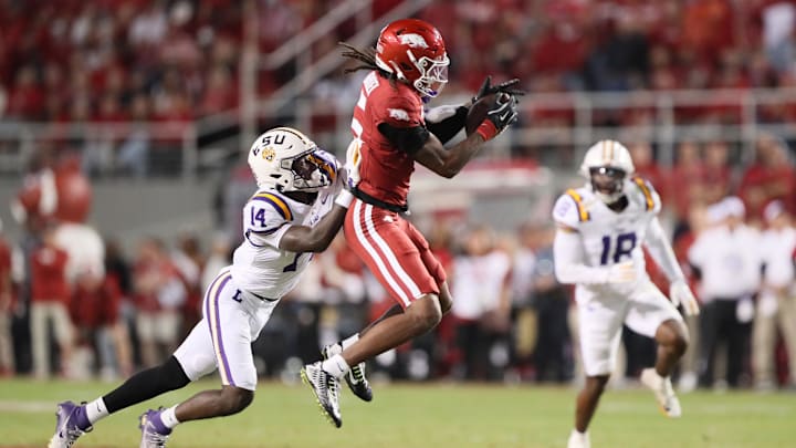 Oct 19, 2024; Fayetteville, Arkansas, USA; Arkansas Razorbacks wide receiver Tyrone Broken (5) attempts a catch as LSU Tigers cornerback Zy Alexander (14) defends at Donald W. Reynolds Razorback Stadium. Mandatory Credit: Nelson Chenault-Imagn Images