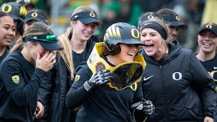 Oregon players celebrate a home run by Oregon catcher Vallery Wong as the Oregon Ducks host Washington Saturday, April 6, 2024 at Jane Sanders Stadium in Eugene, Ore.