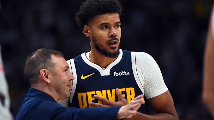 Oct 25, 2025; Denver, Colorado, USA; Denver Nuggets forward Cameron Johnson (23) talks with head coach David Adelman during the first half against the Phoenix Suns at Ball Arena. Mandatory Credit: Christopher Hanewinckel-Imagn Images