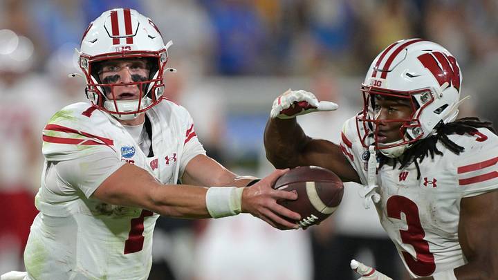 Wisconsin Badgers quarterback Colton Joseph (1) hands off to running back Abu Sama III (3). Wisconsin Badgers quarterback Colton Joseph (1) hands off to running back Abu Sama III (3).