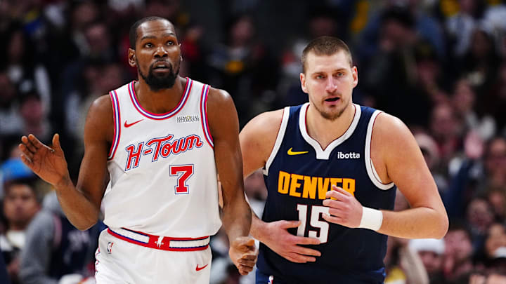 Dec 15, 2025; Denver, Colorado, USA; Houston Rockets forward Kevin Durant (7) and Denver Nuggets center Nikola Jokic (15) during the second quarter at Ball Arena. Mandatory Credit: Ron Chenoy-Imagn Images