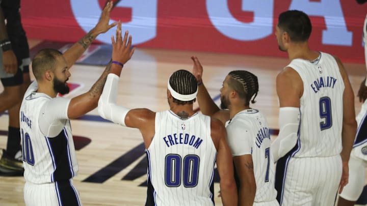 Aug 2, 2020; Lake Buena Vista, Florida, USA; Orlando Magic guard Evan Fournier (10), forward Aaron Gordon (00), guard Michael Carter-Williams (7), and center Nikola Vucevic (9) celebrate in the second half of a NBA basketball game against the Sacramento Kings at HP Field House. Mandatory Credit: Kim Klement-Imagn Images Aug 2, 2020; Lake Buena Vista, Florida, USA; Orlando Magic guard Evan Fournier (10), forward Aaron Gordon (00), guard Michael Carter-Williams (7), and center Nikola Vucevic (9) celebrate in the second half of a NBA basketball game against the Sacramento Kings at HP Field House. Mandatory Credit: Kim Klement-Imagn Images