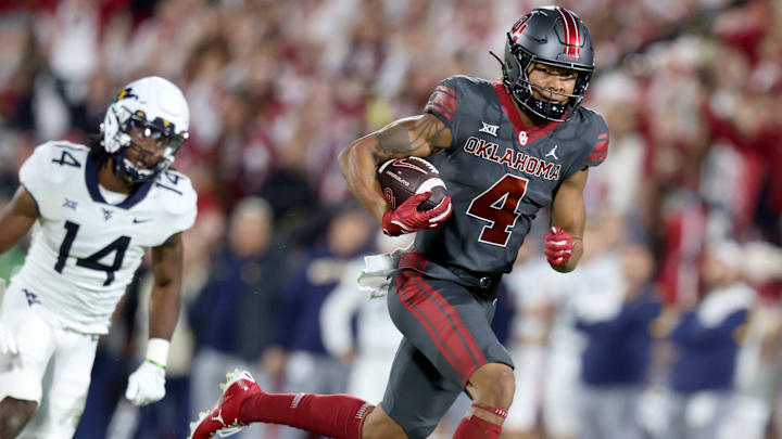 Oklahoma's Nic Anderson (4) runs after a reception as West Virginia's Malachi Ruffin (14) chases him in the first half of a college football game between the University of Oklahoma Sooners and the West Virginia Mountaineers at Gaylord Family-Oklahoma Memorial Stadium in Norman, Okla., Saturday, Nov., 11, 2023. Oklahoma's Nic Anderson (4) runs after a reception as West Virginia's Malachi Ruffin (14) chases him in the first half of a college football game between the University of Oklahoma Sooners and the West Virginia Mountaineers at Gaylord Family-Oklahoma Memorial Stadium in Norman, Okla., Saturday, Nov., 11, 2023.