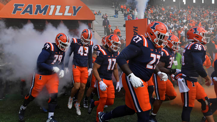 Nov 16, 2024; Champaign, Illinois, USA;  Illinois fighting Illini players take the field against the Michigan State Spartans at Memorial Stadium. Mandatory Credit: Ron Johnson-Imagn Images