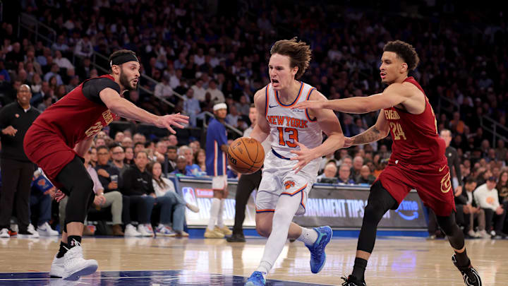 Oct 22, 2025; New York, New York, USA; New York Knicks guard Tyler Kolek (13) drives to the basket against Cleveland Cavaliers forward Larry Nance Jr. (22) and guard Tyrese Proctor (24) during the third quarter at Madison Square Garden. Mandatory Credit: Brad Penner-Imagn Images