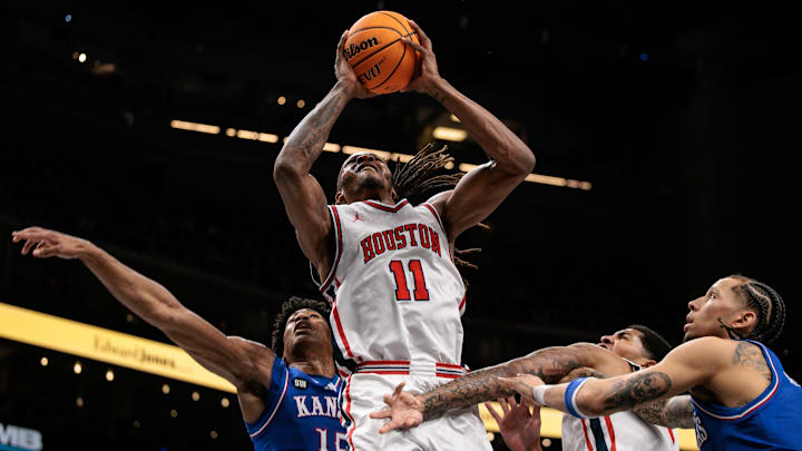 Mar 13, 2026; Kansas City, MO, USA; Houston Cougars forward Joseph Tugler (11) shoots the ball in front of Kansas Jayhawks forward Bryson Tiller (15) during the first half at T-Mobile Center. Mandatory Credit: William Purnell-Imagn Images