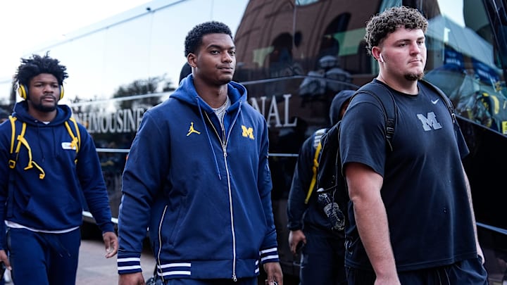Michigan defensive back Will Johnson (2), center, and defensive lineman Mason Graham (55) walk towards locker room as the team arrive before the Michigan State game at Michigan Stadium in Ann Arbor on Saturday, Oct. 26, 2024.
