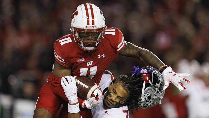 Ohio State Buckeyes cornerback Jordan Hancock (7) loses his helmet while trying to tackle Wisconsin Badgers wide receiver Skyler Bell (11) during the fourth quarter at Camp Randall Stadium.