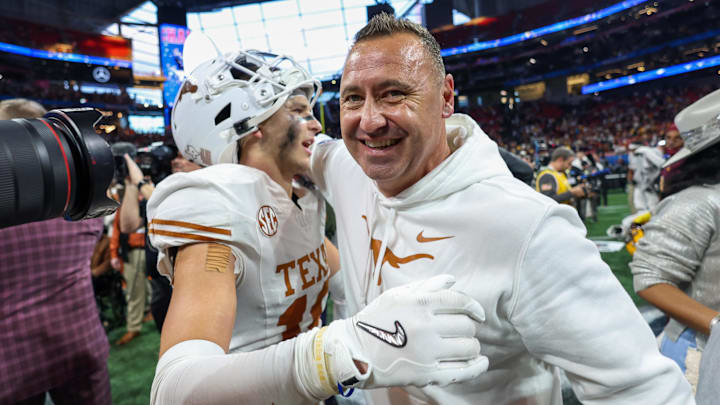 Jan 1, 2025; Atlanta, GA, USA; Texas Longhorns defensive back Michael Taaffe (16) and head coach Steve Sarkisian celebrate after a victory over the Arizona State Sun Devils in the Peach Bowl at Mercedes-Benz Stadium. Mandatory Credit: Brett Davis-Imagn Images