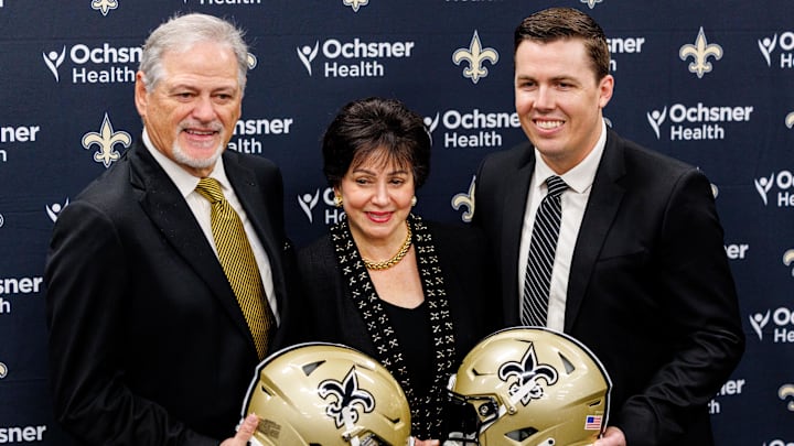 Feb 13, 2025; New Orleans, LA, USA;  New Orleans Saints owner Gayle Benson and general manager Mickey Loomis pose with the new head coach Kellen Moore at Ochsner Sports Performance Center. Mandatory Credit: Stephen Lew-Imagn Images