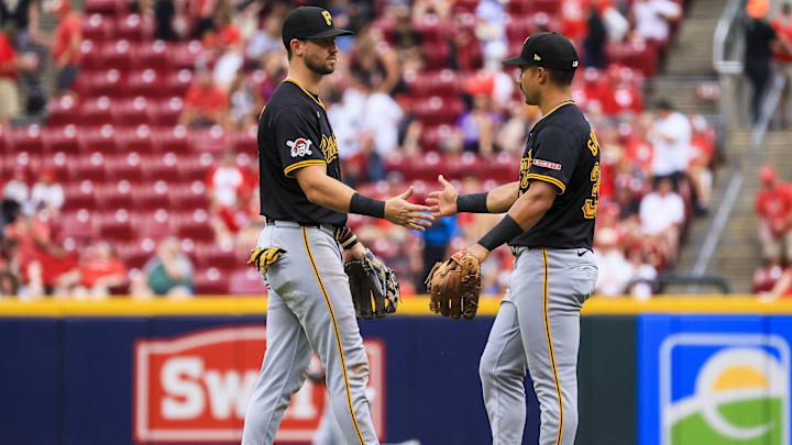 Sep 22, 2024; Cincinnati, Ohio, USA; Pittsburgh Pirates third baseman Jared Triolo (19) high fives shortstop Nick Gonzales (39) after the victory over the Cincinnati Reds at Great American Ball Park. Mandatory Credit: Katie Stratman-Imagn Images