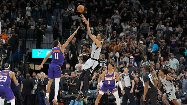 Mar 19, 2026; San Antonio, Texas, USA;  San Antonio Spurs forward Victor Wembanyama (1) shoots the game winning shot over Phoenix Suns forward Oso Ighodaro (11) in the second half at Frost Bank Center. Mandatory Credit: Daniel Dunn-Imagn Images