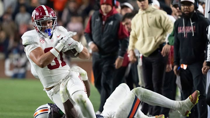 Nov 29, 2025; Auburn, Alabama, USA; Alabama tight end Kaleb Edwards (81) is brought down by an Auburn defender at Jordan-Hare Stadium. Alabama defeated Auburn 27-20. Mandatory Credit: Gary Cosby Jr.-Tuscaloosa News