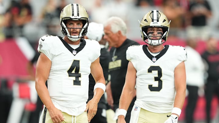 Aug 10, 2024; Glendale, Arizona, USA; New Orleans Saints quarterback Derek Carr (4) and New Orleans Saints quarterback Jake Haener (3) warm up before facing the Arizona Cardinals at State Farm Stadium. Mandatory Credit: Joe Camporeale-Imagn Images