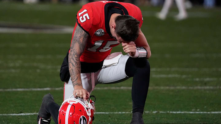 Georgia quarterback Carson Beck (15) prays before the start of the first half of a NCAA college football game against Georgia Tech in Athens, Ga., on Friday, Nov. 29, 2024.