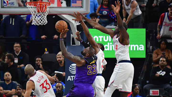 Jan 19, 2025; Inglewood, California, USA; Los Angeles Clippers forward Kawhi Leonard (2) and center Mo Bamba (4) defend against Los Angeles Lakers forward LeBron James (23) during the first half at Intuit Dome. Mandatory Credit: Gary A. Vasquez-Imagn Images