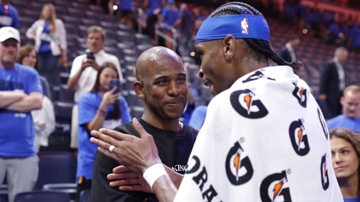 May 22, 2025; Oklahoma City, Oklahoma, USA; Oklahoma City Thunder guard Shai Gilgeous-Alexander (2) talks to Chris Paul after defeating the Minnesota Timberwolves during game two of the western conference finals for the 2025 NBA Playoffs at Paycom Center. Mandatory Credit: Alonzo Adams-Imagn Images