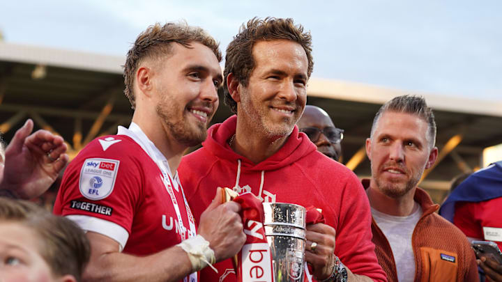 Ryan Reynolds celebrates Wrexham's promotion with forward Sam Smith