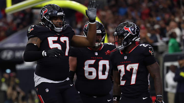 Dec 14, 2025; Houston, Texas, USA; Houston Texans running back Woody Marks (27), offensive tackle Blake Fisher (57) and center Jake Andrews (60) celebrate a touchdown during the first quarter against the Arizona Cardinals at NRG Stadium. Mandatory Credit: Thomas Shea-Imagn Images