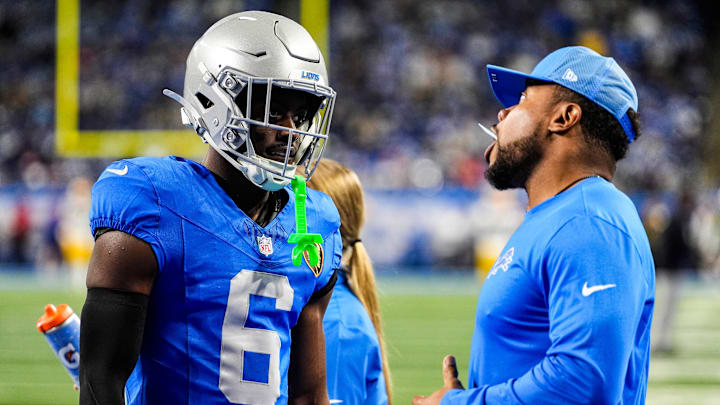Detroit Lions cornerback Terrion Arnold (6) talks to running backs coach Tashard Rice at warmup ahead of the Green Bay Packers game at Ford Field in Detroit on Thursday, Nov. 27, 2025.