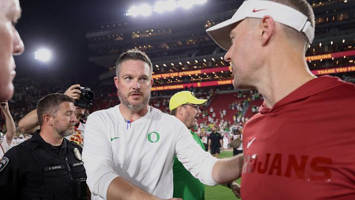 Sep 26, 2026; Los Angeles, California, USA;  Oregon Ducks head coach Dan Lanning (left) shakes hands with USC Trojans head coach Lincoln Riley after the game at United Airlines Field at Los Angeles Memorial Coliseum.  Mandatory Credit: Kiyoshi Mio-Imagn Images