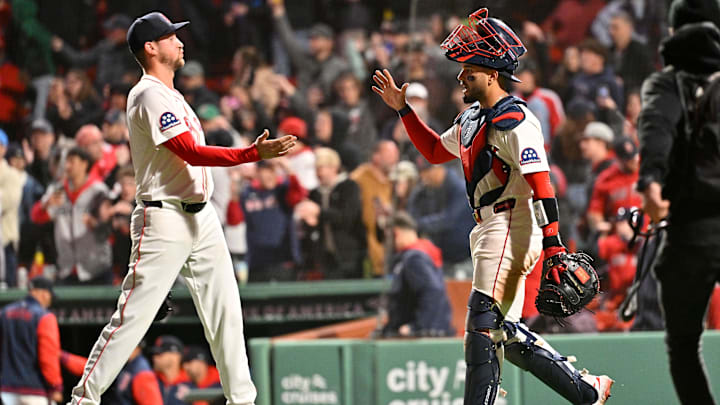 Apr 6, 2025; Boston, Massachusetts, USA; Boston Red Sox catcher Carlos Narvaez (75) and relief pitcher Cooper Criswell (64) celebrate defeating the St. Louis Cardinals at Fenway Park. Mandatory Credit: Eric Canha-Imagn Images