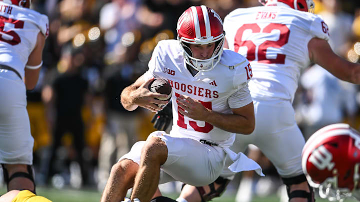 Sep 27, 2025; Iowa City, Iowa, USA; Indiana Hoosiers quarterback Fernando Mendoza (15) is sacked by Iowa Hawkeyes defensive lineman Aaron Graves (95) during the first quarter at Kinnick Stadium. Mandatory Credit: Jeffrey Becker-Imagn Images