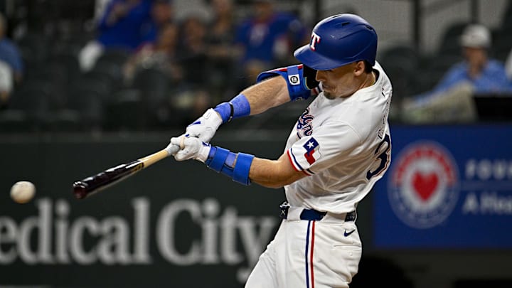 May 2, 2024; Arlington, Texas, USA; Texas Rangers center fielder Evan Carter (32) hits a singles and drives in a run against the Washington Nationals during the second inning at Globe Life Field. 