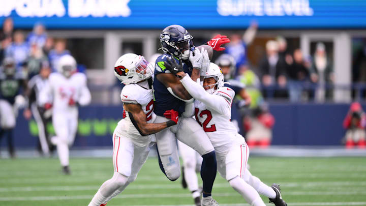 Nov 24, 2024; Seattle, Washington, USA; Arizona Cardinals cornerback Sean Murphy-Bunting (23) and safety Dadrion Taylor-Demerson (42) break up a pass intended for Seattle Seahawks wide receiver DK Metcalf (14) during the first half at Lumen Field. Mandatory Credit: Steven Bisig-Imagn Images