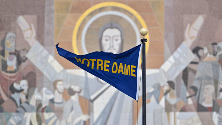 Nov 19, 2022; South Bend, Indiana, USA; A Notre Dame pennant flies in front of the Word of Life Mural, commonly known as Touchdown Jesus, before the game between the Notre Dame Fighting Irish and the Boston College Eagles at Notre Dame Stadium. Mandatory Credit: Matt Cashore-Imagn Images