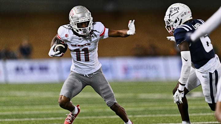 Oct 11, 2024; Logan, Utah, USA;  UNLV Rebels wide receiver Ricky White III (11) runs with the ball against the Utah State Aggies at Merlin Olsen Field at Maverik Stadium. Mandatory Credit: Jamie Sabau-Imagn Images