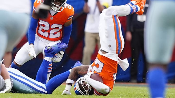 Oct 26, 2025; Denver, Colorado, USA; Denver Broncos cornerback Jahdae Barron (23) intercepts the ball against the Dallas Cowboys in the second quarter at Empower Field at Mile High.