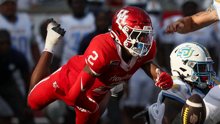 Sep 12, 2026; Houston, Texas, USA; Houston Cougars cornerback Jalen Mayo (2) strips the ball away from Southern University Jaguars quarterback Christian Johnson (10) during the first quarter at TDECU Stadium. Mandatory Credit: Troy Taormina-Imagn Images
