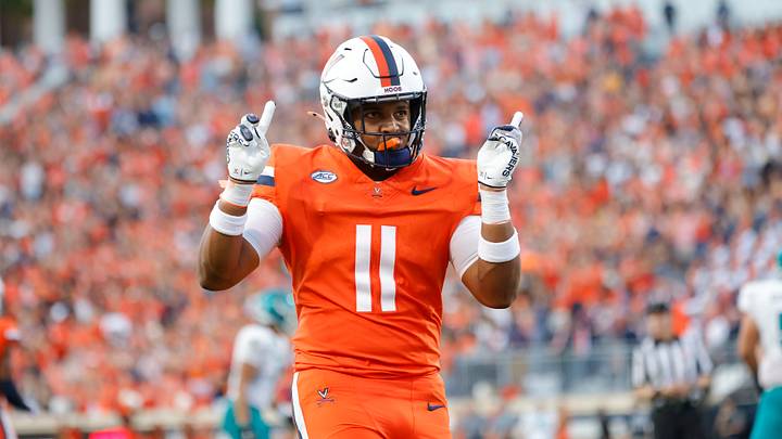 Aug 30, 2025; Charlottesville, Virginia, USA; Virginia Cavaliers linebacker Maddox Marcellus (11) celebrates after intercepting a ball against the Coastal Carolina Chanticleers during the second quarter at Scott Stadium. Mandatory Credit: Amber Searls-Imagn Images