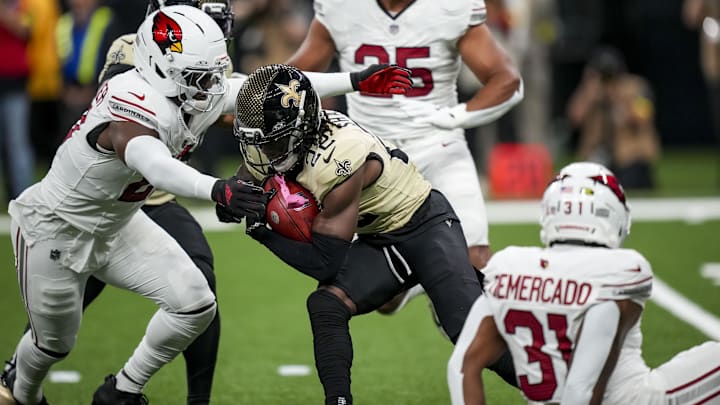 Sep 7, 2025; New Orleans, Louisiana, USA; New Orleans Saints wide receiver Rashid Shaheed (22) is tackled by Arizona Cardinals running back Michael Carter (22) during the first quarter at Caesars Superdome. Mandatory Credit: Matthew Hinton-Imagn Images