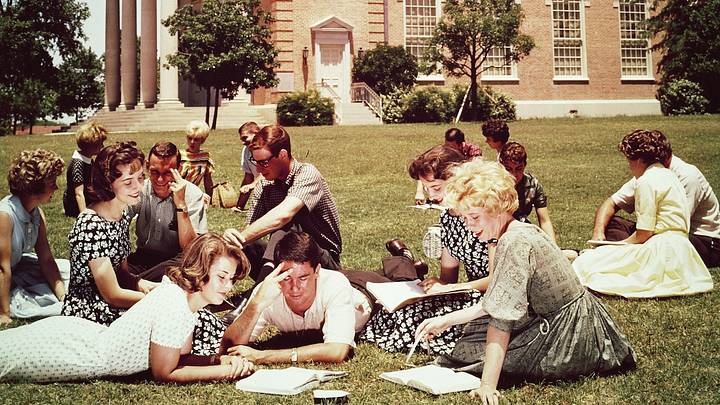 College students studying on the lawn on campus, 1970. College students studying on the lawn on campus, 1970.