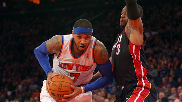 Feb 1, 2014; New York, NY, USA; New York Knicks small forward Carmelo Anthony (7) drives against Miami Heat shooting guard Dwyane Wade (3) during the fourth quarter of a game at Madison Square Garden. The Heat defeated the Knicks 106-91. Mandatory Credit: Brad Penner-Imagn Images