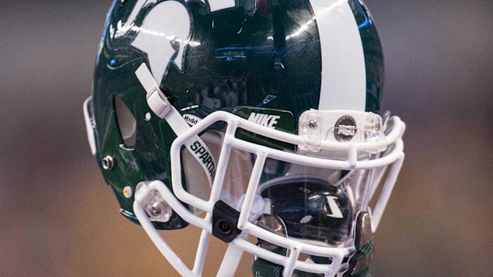 Jan 1, 2015; Arlington, TX, USA; A player holds up his Michigan State Spartans helmet during the