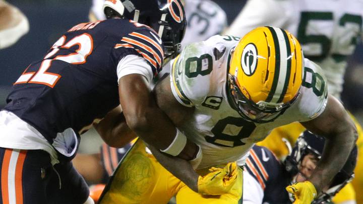 Jan 10, 2026; Chicago, IL, USA; Chicago Bears safety Elijah Hicks (22) punches the ball loose from Green Bay Packers running back Josh Jacobs (8) during an NFC Wild Card Round game at Soldier Field. Mandatory Credit: Wm. Glasheen/USA TODAY Network via Imagn Images