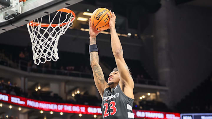 Mar 12, 2025; Kansas City, MO, USA; Cincinnati Bearcats forward Dillon Mitchell (23) dunks during the second half against the Iowa State Cyclones at T-Mobile Center. Mandatory Credit: William Purnell-Imagn Images