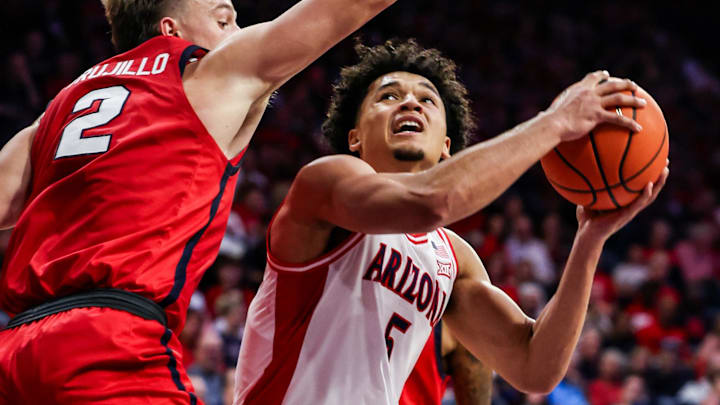 Nov 7, 2025; Tucson, Arizona, USA; Arizona Wildcats guard Brayden Burries (5) looks to shoot the ball while Utah Tech Trailblazers guard Chance Trujillo (2) attempts to block him during the second half of the game at McKale Memorial Center. Mandatory Credit: Aryanna Frank-Imagn Images