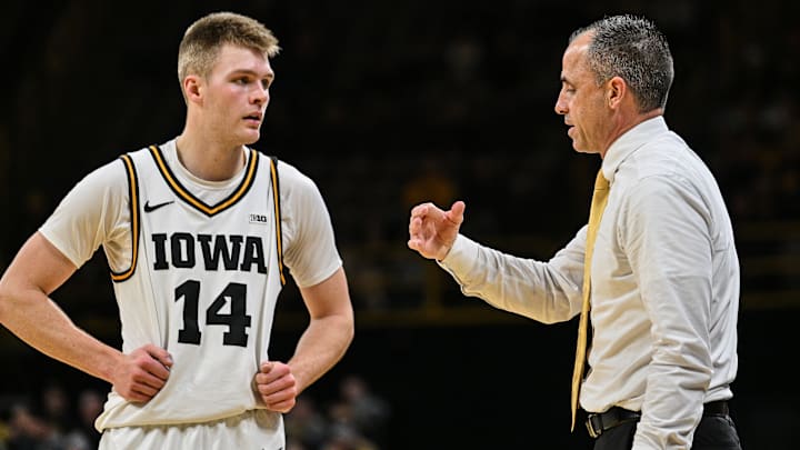 Iowa Hawkeyes guard Bennett Stirtz (14) and head coach Ben McCollum Iowa Hawkeyes guard Bennett Stirtz (14) and head coach Ben McCollum