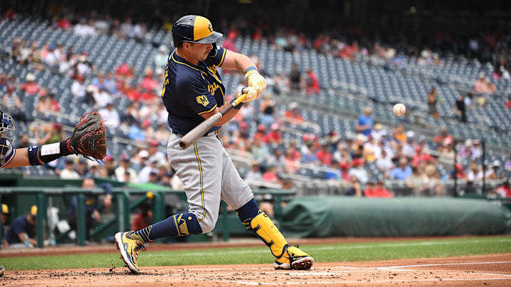 Aug 4, 2024; Washington, District of Columbia, USA; Milwaukee Brewers first baseman Rhys Hoskins (12) hits the ball into play against the Washington Nationals during the second inning at Nationals Park.