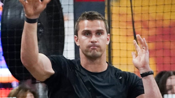 Former Cincinnati Bengals player Sam Hubbard throws a football at bowling pins during the 2025 Sam Hubbard Foundation Fowling Tournament, Thursday, May 15, 2025, at Fowling Warehouse in Cincinnati.
