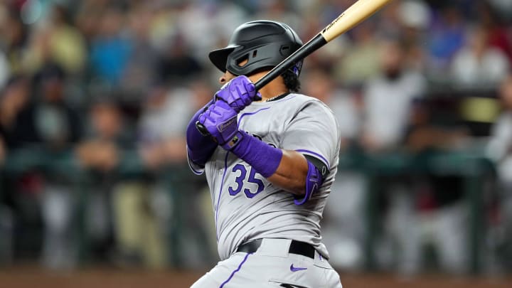 Mar 28, 2024; Phoenix, Arizona, USA; Colorado Rockies catcher Elias Diaz (35) hits a single against the Arizona Diamondbacks during the fourth inning at Chase Field.