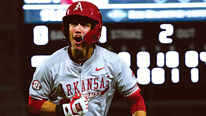 Having just hit a monster home run that cleared the scoreboard at Alabama, the Arkansas Razorbacks' TJ Pompey celebrates.