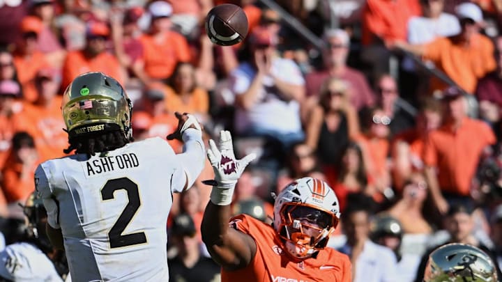 Oct 4, 2025; Blacksburg, Virginia, USA; Wake Forest Demon Deacons quarterback Robby Ashford (2) throws a pass against Virginia Tech Hokies defensive lineman Kemari Copeland (13) during the fourth quarter at Lane Stadium. Mandatory Credit: Brian Bishop-Imagn Images