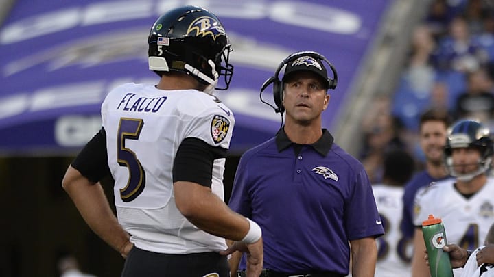Aug 13, 2015; Baltimore, MD, USA; Baltimore Ravens quarterback Joe Flacco (5) speaks with head coach John Harbaugh during the first quarter against the New Orleans Saints in a preseason NFL football game at M&T Bank Stadium. Mandatory Credit: Tommy Gilligan-Imagn Images